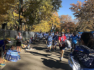 NYC Marathon. The spotters do not like you to sit down close to the finish.  This is for your wellbeing rather than a security thing.  Keep moving until you start to recover.